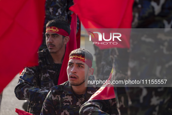 Members of the Basij paramilitary force are preparing to march in a military parade marking Iran's Army Day anniversary at an Army military...