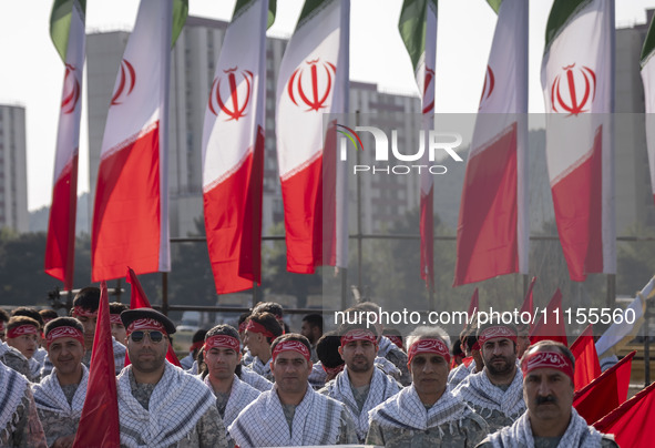 Members of the Basij paramilitary force are posing for a photograph as they prepare to march in a military parade marking Iran's Army Day an...