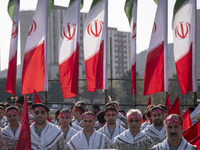 Members of the Basij paramilitary force are posing for a photograph as they prepare to march in a military parade marking Iran's Army Day an...