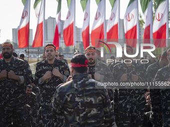 Members of the Basij paramilitary force are preparing to march in a military parade marking Iran's Army Day anniversary at an Army military...