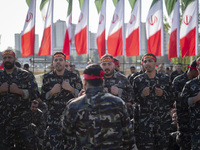 Members of the Basij paramilitary force are preparing to march in a military parade marking Iran's Army Day anniversary at an Army military...