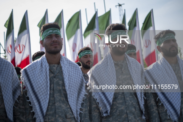 Members of the Basij paramilitary force are preparing to march in a military parade marking Iran's Army Day anniversary at an Army military...