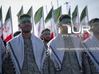 Members of the Basij paramilitary force are preparing to march in a military parade marking Iran's Army Day anniversary at an Army military...