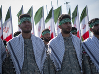 Members of the Basij paramilitary force are preparing to march in a military parade marking Iran's Army Day anniversary at an Army military...