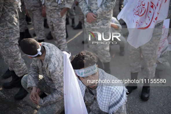 Members of the Basij paramilitary force are preparing to march in a military parade marking Iran's Army Day anniversary at an Army military...