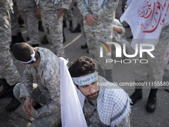 Members of the Basij paramilitary force are preparing to march in a military parade marking Iran's Army Day anniversary at an Army military...