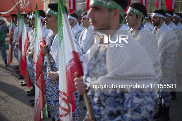 Members of the Basij paramilitary force are preparing to march in a military parade marking Iran's Army Day anniversary at an Army military...