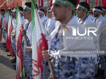 Members of the Basij paramilitary force are preparing to march in a military parade marking Iran's Army Day anniversary at an Army military...