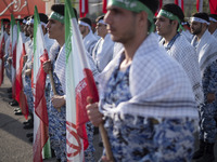 Members of the Basij paramilitary force are preparing to march in a military parade marking Iran's Army Day anniversary at an Army military...