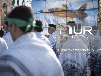 Members of the Basij paramilitary force are preparing to march in a military parade marking Iran's Army Day anniversary at an Army military...