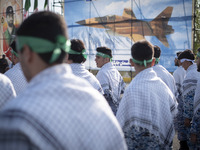 Members of the Basij paramilitary force are preparing to march in a military parade marking Iran's Army Day anniversary at an Army military...