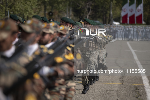 Members of the Iranian Army's land force are marching in a military parade to mark the anniversary of Iran's Army Day at an Army military ba...