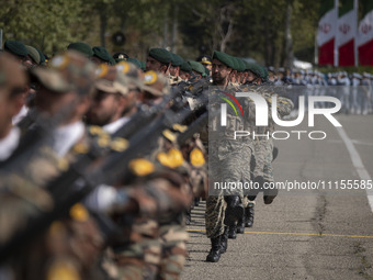 Members of the Iranian Army's land force are marching in a military parade to mark the anniversary of Iran's Army Day at an Army military ba...