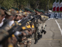 Members of the Iranian Army's land force are marching in a military parade to mark the anniversary of Iran's Army Day at an Army military ba...