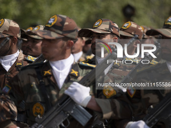 Members of the Iranian Army's land force are marching in a military parade to mark the anniversary of Iran's Army Day at an Army military ba...