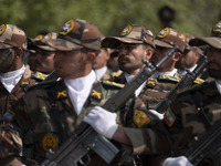 Members of the Iranian Army's land force are marching in a military parade to mark the anniversary of Iran's Army Day at an Army military ba...