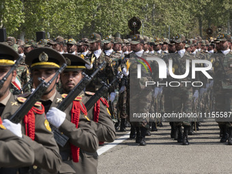 Members of the Iranian Army's land force are marching in a military parade to mark the anniversary of Iran's Army Day at an Army military ba...