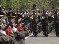 Members of the Iranian Army's land force are marching in a military parade to mark the anniversary of Iran's Army Day at an Army military ba...