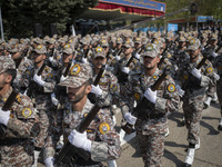 Members of the Iranian Army's land force are marching in a military parade to mark the anniversary of Iran's Army Day at an Army military ba...