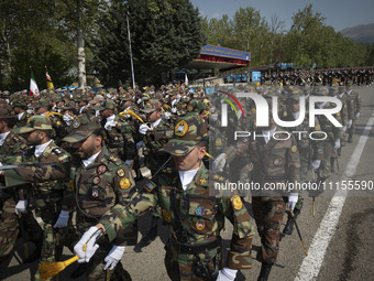 Members of the Iranian Army's land force are marching in a military parade to mark the anniversary of Iran's Army Day at an Army military ba...