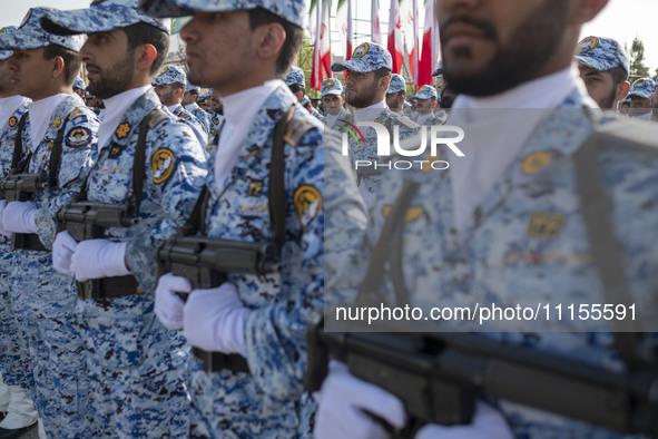 Members of the Iranian Army's air force are marching in a military parade to mark the anniversary of Iran's Army Day at an Army military bas...