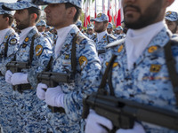 Members of the Iranian Army's air force are marching in a military parade to mark the anniversary of Iran's Army Day at an Army military bas...