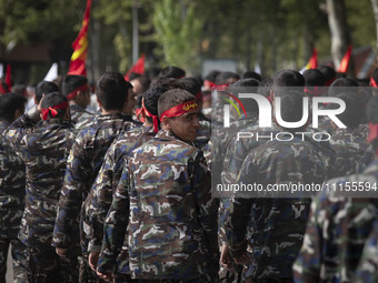 A member of the Basij paramilitary force is looking back while marching in a military parade to mark Iran's Army Day anniversary at an Army...