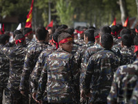 A member of the Basij paramilitary force is looking back while marching in a military parade to mark Iran's Army Day anniversary at an Army...