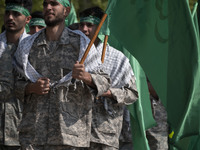 Members of the Basij paramilitary force are marching in a military parade to mark the anniversary of Iran's Army Day at an Army military bas...