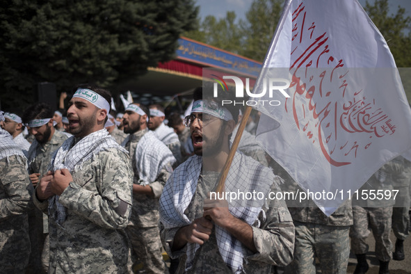 Members of the Basij paramilitary force are marching in a military parade to mark the anniversary of Iran's Army Day at an Army military bas...