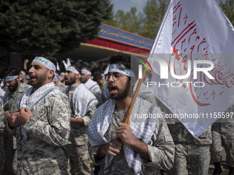 Members of the Basij paramilitary force are marching in a military parade to mark the anniversary of Iran's Army Day at an Army military bas...