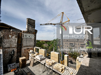 A residential building at 80 Nezalezhnoi Ukrainy Street/3 Yakova Novytskoho Street is undergoing reconstruction after being destroyed by Rus...