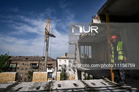 A residential building at 80 Nezalezhnoi Ukrainy Street/3 Yakova Novytskoho Street is undergoing reconstruction after being destroyed by Rus...