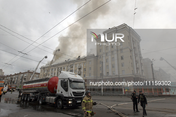 Rescue vehicles are outside the residential building damaged by the Russian missile attack in Dnipro, Ukraine, on April 19, 2024. 