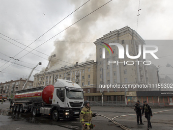 Rescue vehicles are outside the residential building damaged by the Russian missile attack in Dnipro, Ukraine, on April 19, 2024. (