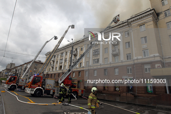 Rescue vehicles are outside the residential building damaged by the Russian missile attack in Dnipro, Ukraine, on April 19, 2024. 