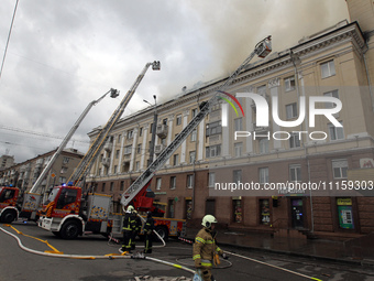 Rescue vehicles are outside the residential building damaged by the Russian missile attack in Dnipro, Ukraine, on April 19, 2024. (