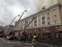 Rescue vehicles are outside the residential building damaged by the Russian missile attack in Dnipro, Ukraine, on April 19, 2024. (