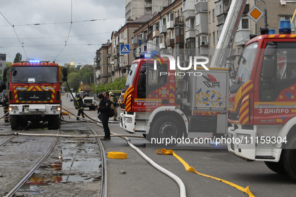 Rescue vehicles are outside the residential building damaged by the Russian missile attack in Dnipro, Ukraine, on April 19, 2024. 