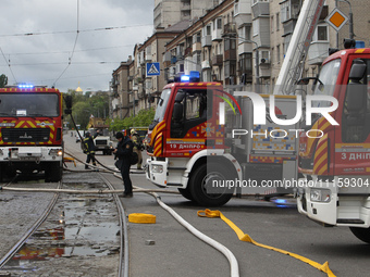 Rescue vehicles are outside the residential building damaged by the Russian missile attack in Dnipro, Ukraine, on April 19, 2024. (