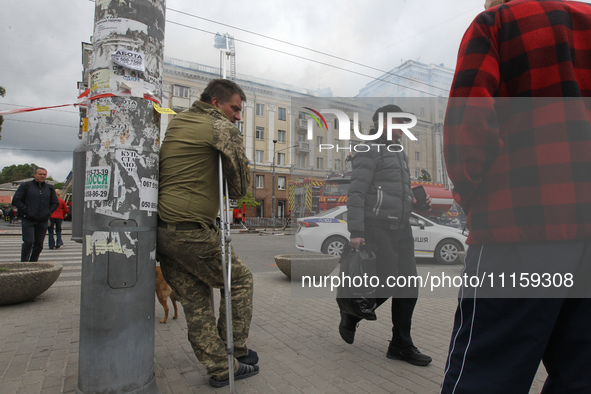 Residents are standing outside the apartment block that was damaged by the Russian missile attack in Dnipro, Ukraine, on April 19, 2024. 