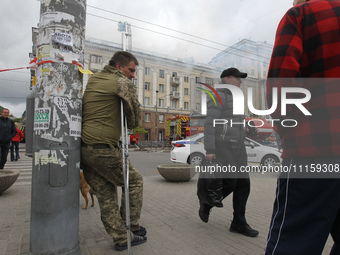 Residents are standing outside the apartment block that was damaged by the Russian missile attack in Dnipro, Ukraine, on April 19, 2024. (