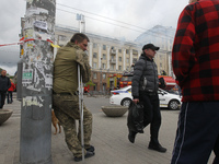 Residents are standing outside the apartment block that was damaged by the Russian missile attack in Dnipro, Ukraine, on April 19, 2024. (