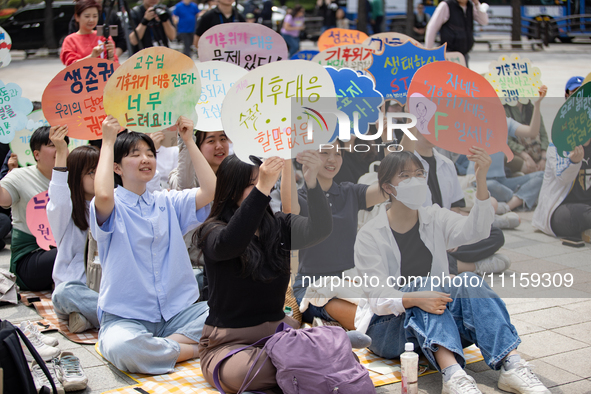 Participants in Seoul, South Korea, are holding up signs they have written themselves during the 4.19 Climate Strike and Youth Climate Actio...