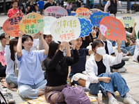 Participants in Seoul, South Korea, are holding up signs they have written themselves during the 4.19 Climate Strike and Youth Climate Actio...