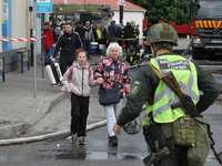 Residents are standing outside the apartment block that was damaged by the Russian missile attack in Dnipro, Ukraine, on April 19, 2024. (