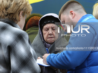 Residents are standing outside the apartment block that was damaged by the Russian missile attack in Dnipro, Ukraine, on April 19, 2024. (