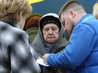 Residents are standing outside the apartment block that was damaged by the Russian missile attack in Dnipro, Ukraine, on April 19, 2024. (