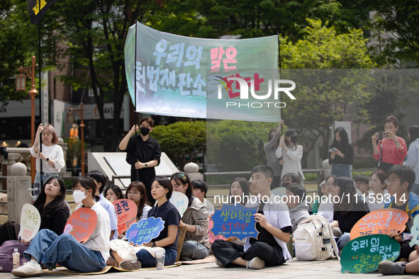 Participants in Seoul, South Korea, are holding up signs they have written themselves during the 4.19 Climate Strike and Youth Climate Actio...