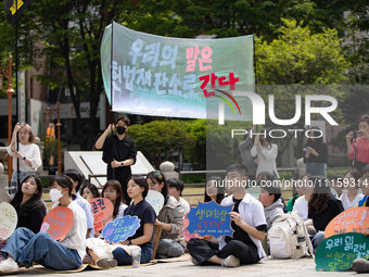 Participants in Seoul, South Korea, are holding up signs they have written themselves during the 4.19 Climate Strike and Youth Climate Actio...